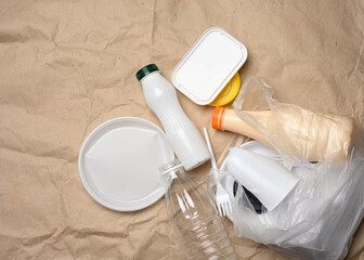 plastic waste from life on the background of brown kraft paper, environmental pollution