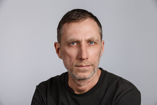 Beard man wearing t-shirt on light gray background. Studio shot