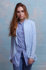 young beautiful Caucasian woman, on a blue background.