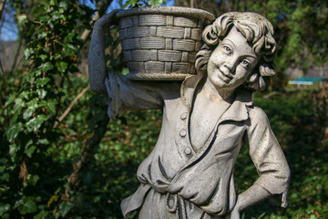 Fototapeta na wymiar photo of a boy wearing a basket, a concrete statue