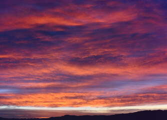 Epic scene of a cloudy sky during sunrise with purple and pink colors