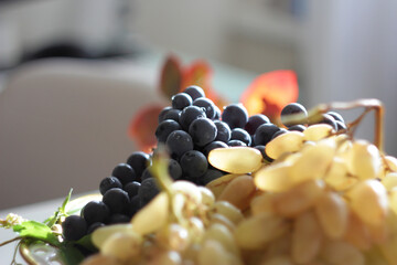White and black grapes on the table 