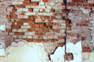 Old brick wall with sprinkled plaster 