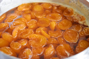 Apricot jam is cooked in a container 