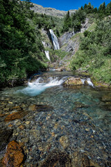 Fototapeta premium triple waterfall in a mountain river of cold, clear, transparent and crystalline waterswaterfall of Saut deth Pish in the Aran Valley, Catalan Pyrenees, Lerida Spain vertical