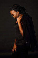 Black afro girl with dreads holding jacket, look down, profile view long dreadlocks, studio shoot, Spain, Vitoria- Gasteiz, March 2021