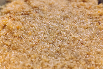 Detail of a bowl with quinoa boiled in hot water, a protein superfood.