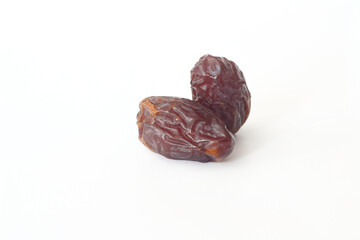 Dates on a white background. Dried fruits. Dried dates lie next to each other