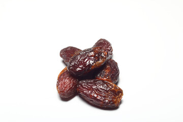 Dates on a white background. Dried fruits. Dried dates lie next to each other