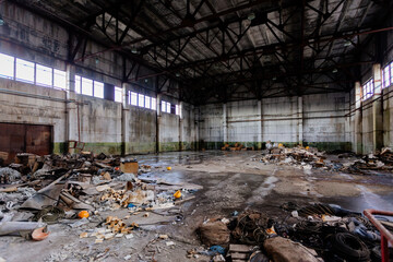Abandoned large industrial hall with garbage waiting for demolition