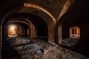 Dark and creepy vaulted red brick dungeon