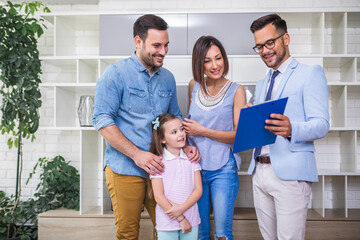 Happy family talking with real estate agent about buying a new home.