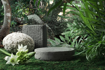Natural stone and concrete podium in tropical forest with flowers. Empty showcase for packaging...