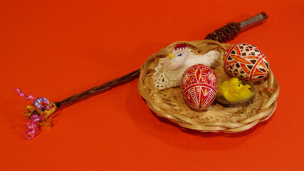 Czech rod with differently colored Easter eggs, red background