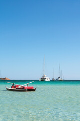 Fototapeta na wymiar Boats and water sports in Cala Brandinchi, Sardinia