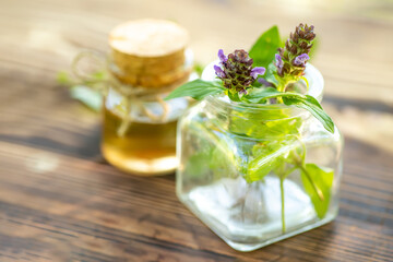 Prunella vulgaris, self-heal, carpenter's herb purple flower tincture in bottle ready for drying and making tea and infusions. Useful herb for use in cosmetology and alternative medicine