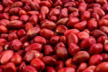 Full frame with red peanuts. Selective focus.