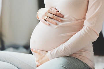 Pregnant woman sitting on chair at home