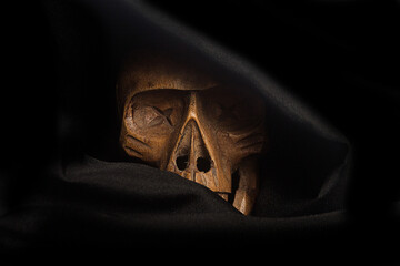 wooden skull covered with black cloth