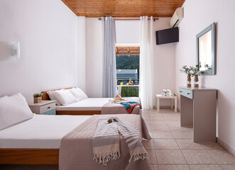 White interior of apartment bedroom with single, double king size bed. Family suit hotel room with...