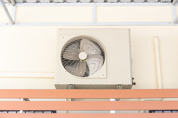Condenser unit or compressor outside home or residential building. Unit of central air conditioner...