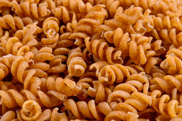 Full frame of wholegrain spiral pasta. Selective focus.
