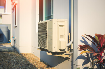 Condenser unit or compressor outside home or residential building. Unit of central air conditioner...