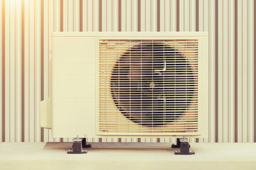 Condenser unit or compressor outside industrial plant building. Unit of central air conditioner...