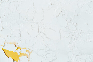 Beautiful white background of decorative plaster with yellow veins. 