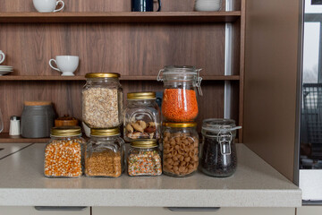 Organization space the kitchen. On the table cereals in glass jars