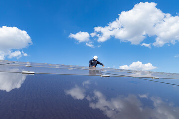 Fototapeta na wymiar The solar farm with the technician is removing the nut to replace the damaged solar panel, Alternative energy to conserve the world's energy, Photovoltaic module idea for clean energy production