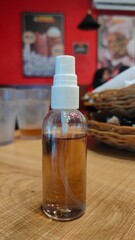 Instant antiseptic aromatic tea and brown color. Hand sanitizer bottle on wood table in the restaurant. Prevent corona virus and covid19