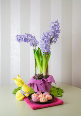 Easter bunny, lilac hyacinths and pink meringues, spring still life, selective focus