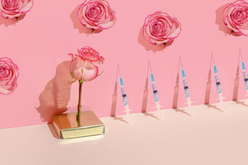 Creative concept of  beauty injections. Syringe with toxin and rose on pastel background - 422881920