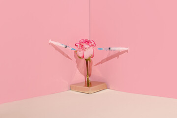 Creative concept of  beauty injections. Syringe with toxin and rose on pastel background