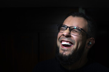 Latin bearded man laughing
