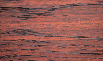 Red mahogany with black veins, close-up of a flat surface of natural wood.