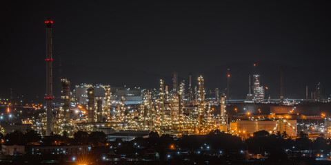 Fototapeta na wymiar The aerial view of oil refinery factory and oil storage tank industry plant power at twilight and night sky background.