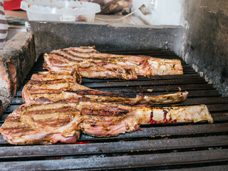 Tomahawk rib beef steak on hot black grill with flames