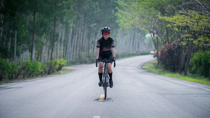 Beautiful biker wearing sport wear sunglass and helmet ride cyclist with her mountain bike in race adventure outdoor game competition on road, extreme healthy sport concept.