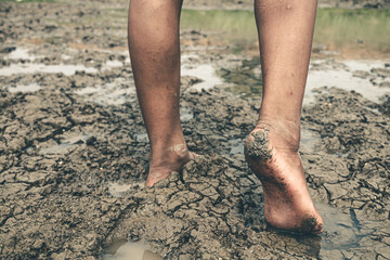 The little boy waiting for drinking water to live through this drought, Concept drought and crisis environment.