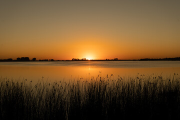 sunset on an orange lake 

