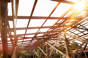 Standard wooden structure building with mounting distance, installation of wooden beams in the construction of the roof truss system of the house.