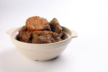 Asian style Beef bhuna dry curry with potato in ceramic bowl over white background
