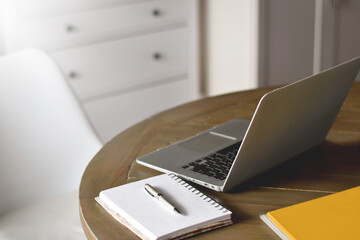 Table with laptop computer and notebook