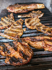 Tomahawk rib beef steak on hot black grill with flames