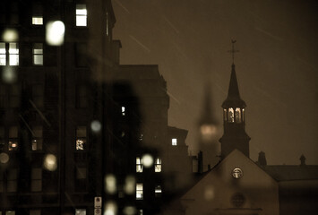A church spire in Old Québec City, Canada, on a snowy winter night - obrazy, fototapety, plakaty