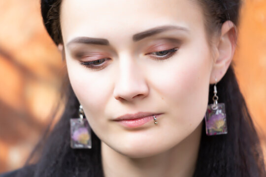 Portrait of a beautiful young woman with a lip piercing