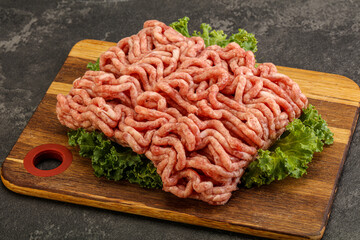 Raw pork minced meat over board