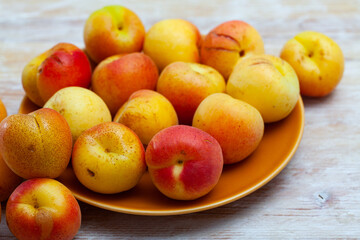 Naklejka na ściany i meble Apricots fruit on wooden table closeup. Vitamin fruits